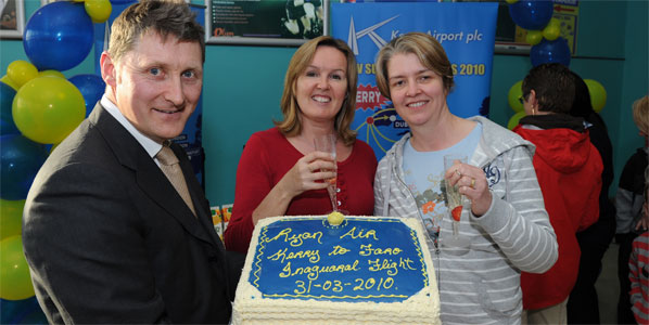 Noel Ryan, sales & marketing executive Kerry Airport, offers some cake to two lucky passengers on the first Ryanair flight from Kerry to Faro. Photo: Domnick Walsh/Eye Focus