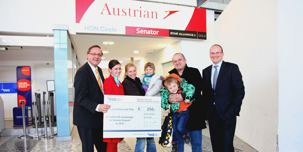 Vienna Airport’s joint CEOs Dr Günther Ofner (left) and Julian Jäger (right) yesterday presented the airport’s 20-millionth passenger; Josef Kunik and family with a cheque for 250 Euros.