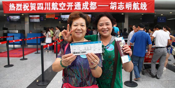 Two passengers pose for Sichuan Airlines Inaugural flight from Chengdu to Ho Chi Ming City.