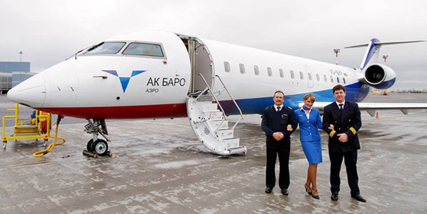 The crew on the first flight are here seen posing in front of the aircraft parked at the Lithuanian capital airport.