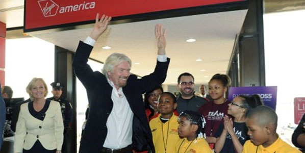 After beginning Newark services in April (illustrated by Sir Richard Branson) 