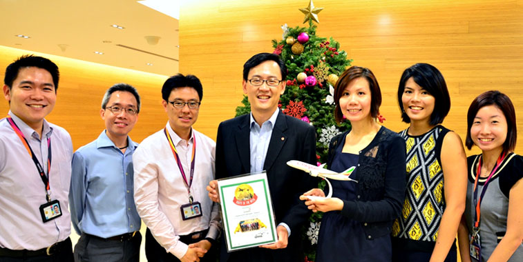 Singapore Changi Airport staff celebrate receiving the anna.aero Route of the Week award