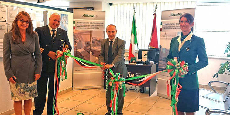 Alitalia celebrating the opening of a new ticketing office in Abu Dhabi with a ribbon cutting ceremony.