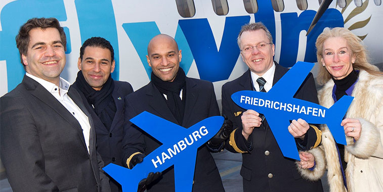 VLM Airlines crew on the first flight from Friedrichshafen celebrate the start of the 11 times weekly service from Southern Germany